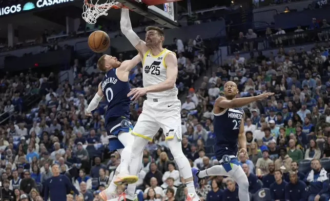 Utah Jazz center Micah Potter (25) dunks against Minnesota Timberwolves guard Donte DiVincenzo (0) during the first half of an NBA basketball game, Sunday, April 13, 2025, in Minneapolis. (AP Photo/Abbie Parr)