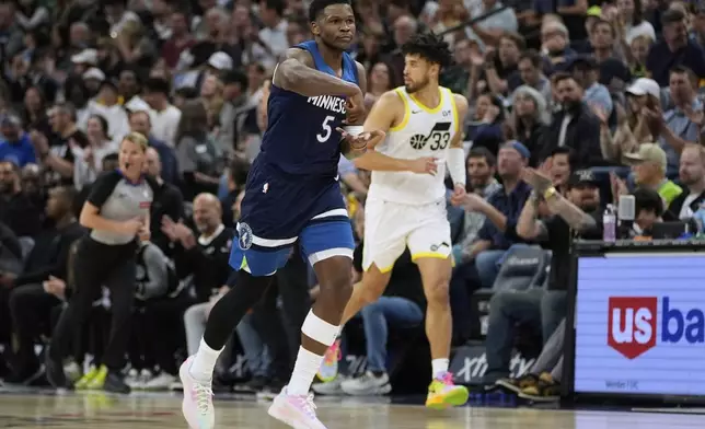 Minnesota Timberwolves guard Anthony Edwards (5) gestures after making a 3-point shot during the first half of an NBA basketball game against the Utah Jazz, Sunday, April 13, 2025, in Minneapolis. (AP Photo/Abbie Parr)
