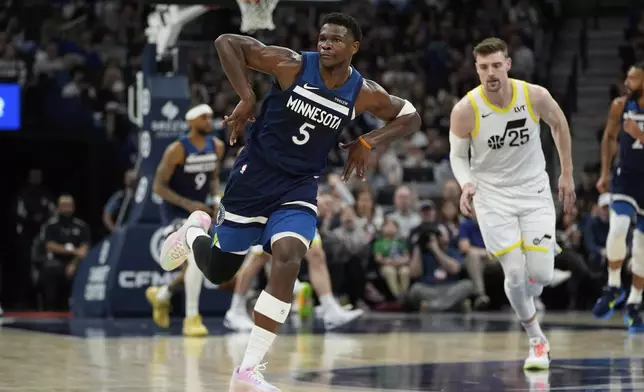 Minnesota Timberwolves guard Anthony Edwards (5) gestures after making a 3-point shot during the first half of an NBA basketball game against the Utah Jazz, Sunday, April 13, 2025, in Minneapolis. (AP Photo/Abbie Parr)