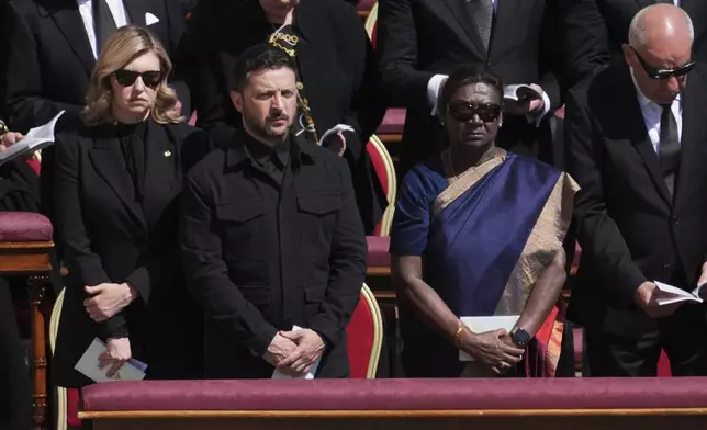 Ukraine's President Volodymr Zelenskyy, front row second from left, and Ukraine's first lady Olena Zelenska, left, and Indian president Droupadi Murmu are seen amongst other dignitaries during the funeral of Pope Francis in St. Peter's Square at the Vatican, Saturday, April 26, 2025. (AP Photo/Evan Vucci)