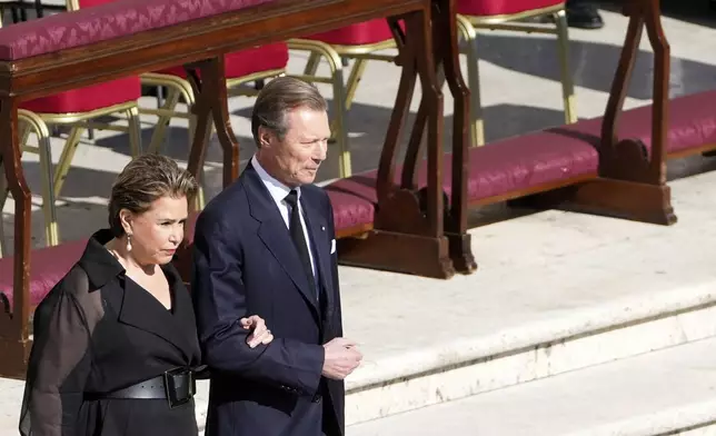Luxembourg's Grand Duke Henri and Grand Duchess Maria Teresa arrive for the funeral of Pope Francis in St. Peter's Square at the Vatican, Saturday, April 26, 2025. (AP Photo/Markus Schreiber)