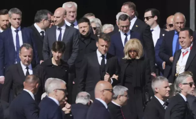 French President Emmanuel Macron, center, and Ukraine's President Volodymr Zelenskyy, background center, and other guests arrive, for the funeral of Pope Francis in St. Peter's Square at the Vatican, Saturday, April 26, 2025. (AP Photo/Andrew Medichini)