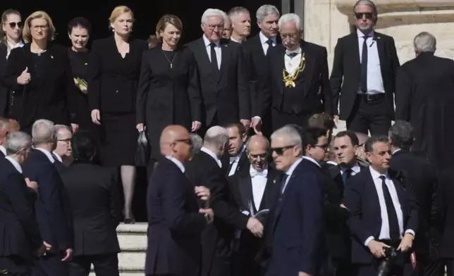 Germany's President Frank Walter Steinmeier, center right, and other guests arrive, for the funeral of Pope Francis in St. Peter's Square at the Vatican, Saturday, April 26, 2025. (AP Photo/Andrew Medichini)
