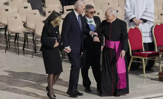 Former President Joe Biden, second from left, and his wife Jill, left, arrive for the funeral of Pope Francis in St. Peter's Square at the Vatican, Saturday, April 26, 2025. (AP Photo/Gregorio Borgia)
