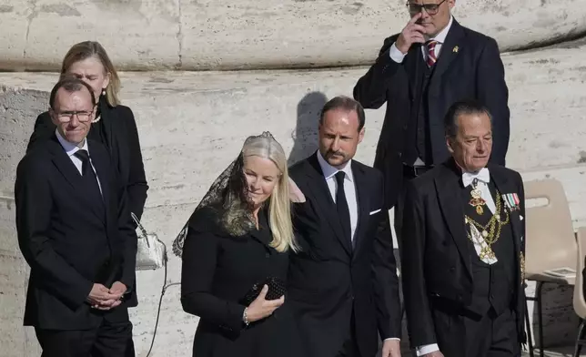 Norway's Crown Prince Haakon, center, and Crown Princess Mette-Marit, center left, arrive for the funeral of Pope Francis in St. Peter's Square at the Vatican, Saturday, April 26, 2025. (AP Photo/Gregorio Borgia)