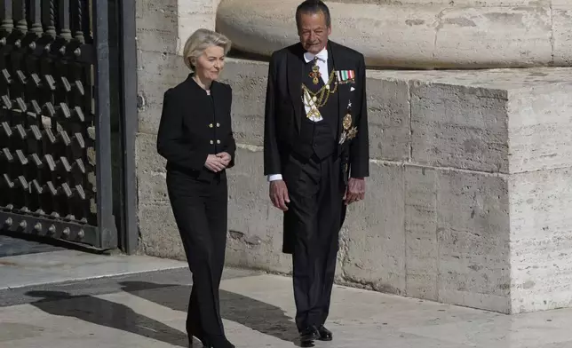 European Commission President Ursula von der Leyen, left, arrives for the funeral of Pope Francis in St. Peter's Square at the Vatican, Saturday, April 26, 2025. (AP Photo/Gregorio Borgia)