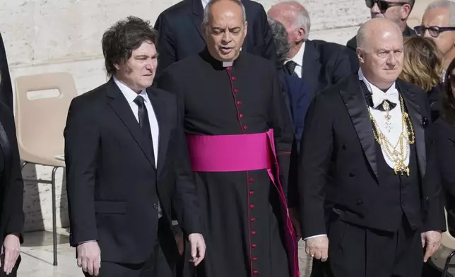 Argentina's President Javier Milei, left, arrives for the funeral of Pope Francis in St. Peter's Square at the Vatican, Saturday, April 26, 2025. (AP Photo/Gregorio Borgia)