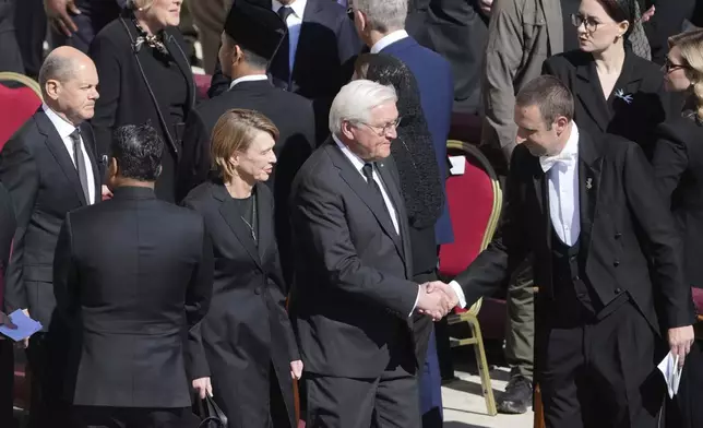 Germany's President Frank Walter Steinmeier, second right, and German Chancellor Olaf Scholz, left, arrive for the funeral of Pope Francis in St. Peter's Square at the Vatican, Saturday, April 26, 2025. (AP Photo/Markus Schreiber)