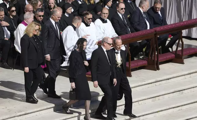 Monaco's Prince Albert, center, and Monaco's Princess Charlene arrive for the funeral of Pope Francis in St. Peter's Square at the Vatican, Saturday, April 26, 2025. (AP Photo/Markus Schreiber)