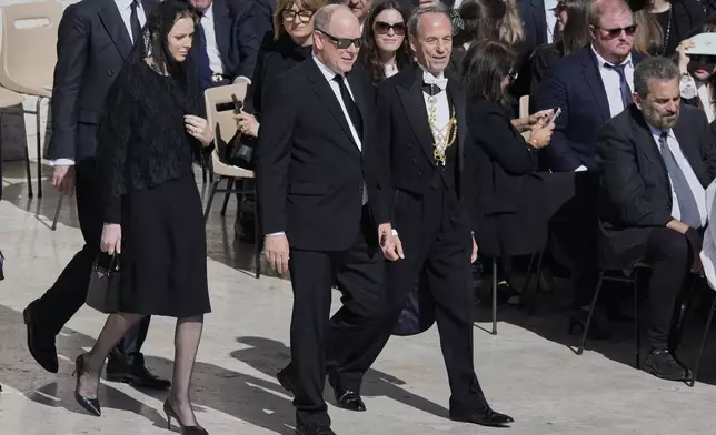 Monaco's Prince Albert, center, and Princess Charlene arrive at the funeral of Pope Francis in St. Peter's Square at the Vatican, Saturday, April 26, 2025. (AP Photo/Gregorio Borgia)