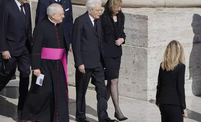 Italy's President Sergio Mattarella, center, and his daughter Laura arrive for the funeral of Pope Francis in St. Peter's Square at the Vatican, Saturday, April 26, 2025. (AP Photo/Gregorio Borgia)