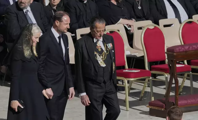 Norway's Crown Prince Haakon, center, and Crown Princess Mette-Marit, left, arrive for the funeral of Pope Francis in St. Peter's Square at the Vatican, Saturday, April 26, 2025. (AP Photo/Gregorio Borgia)