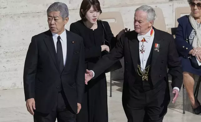 Japan's Foreign Minister Esteri Takeshi Iwaya, left, arrives for the funeral of Pope Francis in St. Peter's Square at the Vatican, Saturday, April 26, 2025. (AP Photo/Gregorio Borgia)