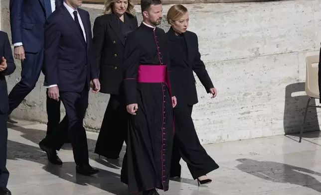 Italy's Prime Minister Giorgia Meloni, right, arrives for the funeral of Pope Francis in St. Peter's Square at the Vatican, Saturday, April 26, 2025. (AP Photo/Gregorio Borgia)