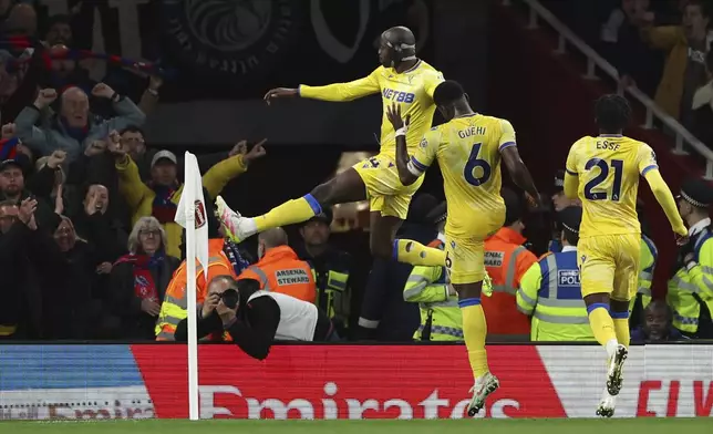 Crystal Palace's Jean-Philippe Mateta, left, celebrates with teammates after scoring his sides second goal during the English Premier League soccer match between Arsenal and Crystal Palace at Emirates stadium in London, Wednesday, April 23, 2025. (AP Photo/Ian Walton)