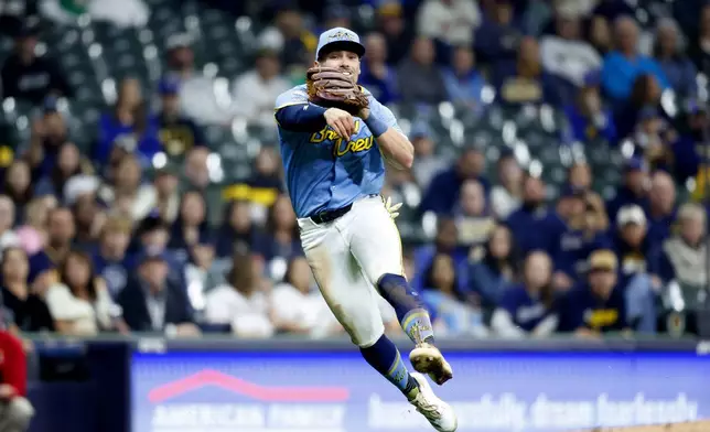 Milwaukee Brewers' Caleb Durbin cannot throw out Athletics' Miguel Andujar during the sixth inning of a baseball game, Friday, April 18, 2025, in Milwaukee. (AP Photo/Jeffrey Phelps)