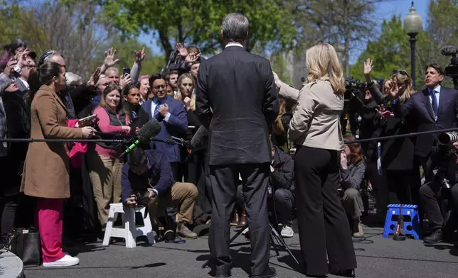 Treasury Secretary Scott Bessent speaks to reporters outside the West Wing of the White House, Wednesday, April 9, 2025, in Washington, with White House press secretary Karoline Leavitt. (AP Photo/Evan Vucci)