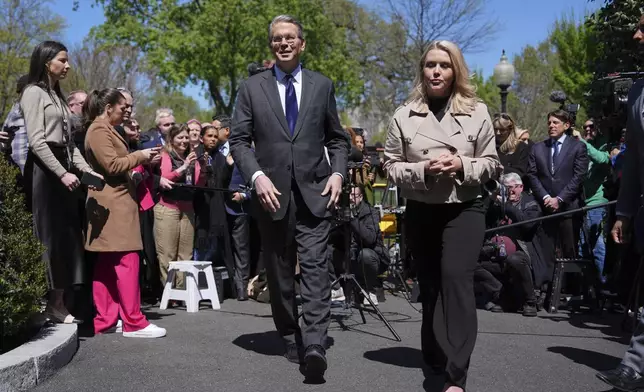Treasury Secretary Scott Bessent and White House press secretary Karoline Leavitt depart after speaking to reporters outside the West Wing of the White House, Wednesday, April 9, 2025, in Washington. (AP Photo/Evan Vucci)