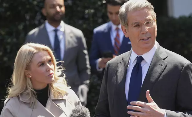 Treasury Secretary Scott Bessent speaks to reporters outside the West Wing of the White House, Wednesday, April 9, 2025, in Washington, with White House press secretary Karoline Leavitt. (AP Photo/Jacquelyn Martin)