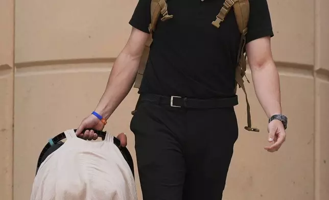 Colby Ryan leaves Maricopa County Superior Court for the murder trial of Lori Vallow Daybell, his mother, who is charged with conspiring to murder her estranged husband, Monday, April 21, 2025, in Phoenix. (AP Photo/Ross D. Franklin)