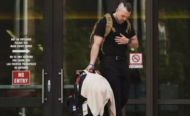 Colby Ryan leaves Maricopa County Superior Court for the murder trial of Lori Vallow Daybell, his mother, who is charged with conspiring to murder her estranged husband, Monday, April 21, 2025, in Phoenix. (AP Photo/Ross D. Franklin)