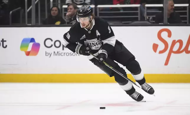 Los Angeles Kings right wing Adrian Kempe gathers the puck during the first period of an NHL hockey game against the Colorado Avalanche, Saturday, April 12, 2025, in Los Angeles. (AP Photo/William Liang)