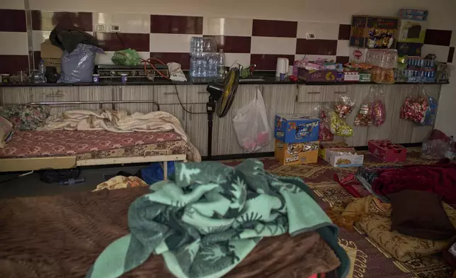 Mattresses and blankets are seen in a compound of a local multipurpose hall that is being used as a temporary shelter for displaced people in the village of Kafr al-Labad, near the West Bank city of Tulkarem, Thursday, April 3, 2025. (AP Photo/Leo Correa)