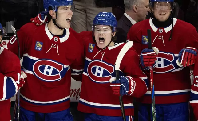Montreal Canadiens' Juraj Slafkovsky (20), Cole Caufield (13) and Patrik Laine (92) celebrate after defeating the Carolina Hurricanes in NHL hockey action in Montreal on Wednesday, April 16, 2025. (Allen McInnis/The Canadian Press via AP)