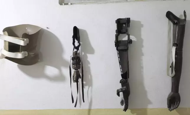Prosthetic which have been serviced for clients, rest on a wall at Ortho-Physiotherapy Centre in Mekele, Tigray region of northern Ethiopia Friday, Feb. 14, 2025. (AP Photo/Amanuel Birhane)