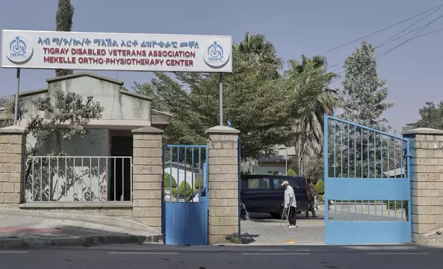 A man walks past a signpost in front of Ortho-Physiotherapy Centre at Mekele in Tigray region of northern Ethiopia Friday, Feb. 14, 2025. (AP Photo/Amanuel Birhane)