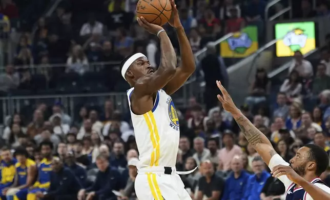 Golden State Warriors forward Jimmy Butler III, left, shoots over Los Angeles Clippers guard Norman Powell during the first half of an NBA basketball game Sunday, April 13, 2025, in San Francisco. (AP Photo/Godofredo A. Vásquez)