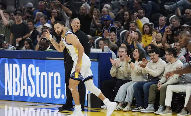 Golden State Warriors guard Stephen Curry reacts after making a 3-point basket during the first half of an NBA basketball game against the Los Angeles Clippers, Sunday, April 13, 2025, in San Francisco. (AP Photo/Godofredo A. Vásquez)