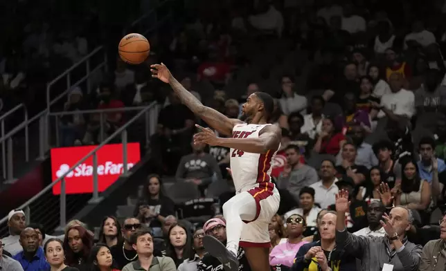 Miami Heat forward Haywood Highsmith (24) keeps the ball in bounds in the first half of an NBA play-in tournament basketball game against the Atlanta Hawks, Friday, April 18, 2025, in Atlanta. (AP Photo/Brynn Anderson)