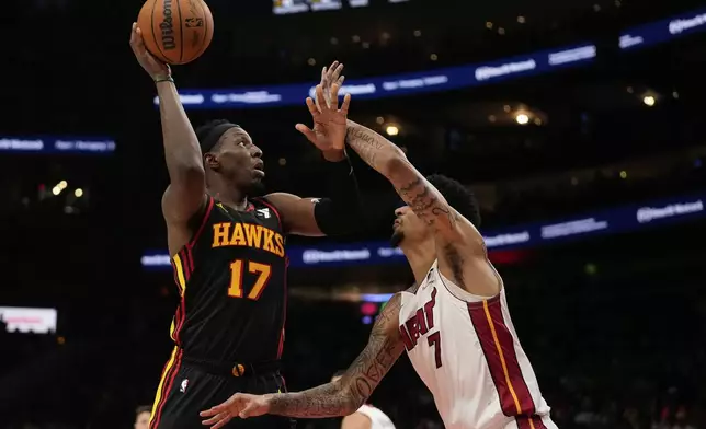 Atlanta Hawks forward Onyeka Okongwu (17) shoots against Miami Heat center Kel'el Ware (7) in the first half of an NBA play-in tournament basketball game, Friday, April 18, 2025, in Atlanta. (AP Photo/Brynn Anderson)