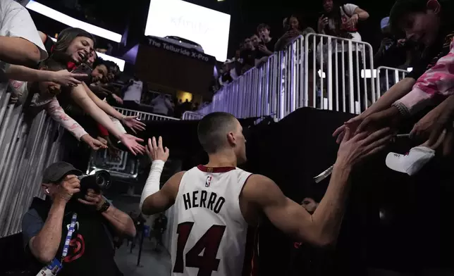 Miami Heat guard Tyler Herro (14) leaves the court after a win against the Atlanta Hawks after an NBA play-in tournament basketball, Friday, April 18, 2025, in Atlanta. (AP Photo/Brynn Anderson)