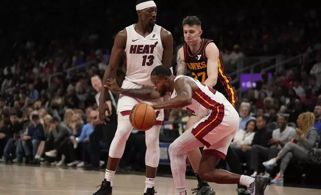 Miami Heat forward Haywood Highsmith (24) dribbles the ball in the first half of an NBA play-in tournament basketball game against the Atlanta Hawks Friday, April 18, 2025, in Atlanta. (AP Photo/Brynn Anderson)