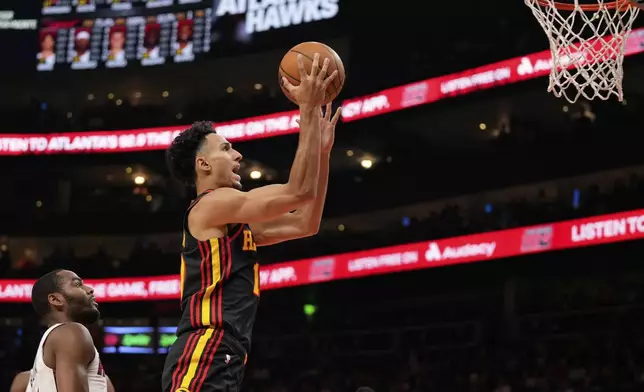 Atlanta Hawks forward Zaccharie Risacher (10) shoots the ball in the first half of an NBA play-in tournament basketball game against the Miami Heat, Friday, April 18, 2025, in Atlanta. (AP Photo/Brynn Anderson)