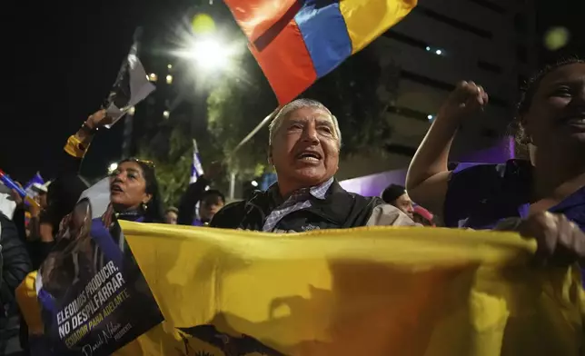 Supporters of President Daniel Noboa celebrate early returns showing him in the lead in the presidential election runoff in Quito, Ecuador, Sunday, April 13, 2025. (AP Photo/Carlos Noriega)