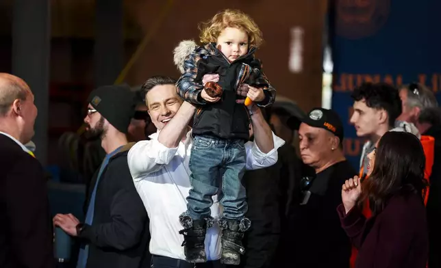 FILE - Conservative Leader Pierre Poilievre lifts his son Cruz up after speaking at a pre-election event in Ottawa, on March 21, 2025. (Justin Tang /The Canadian Press via AP, File)