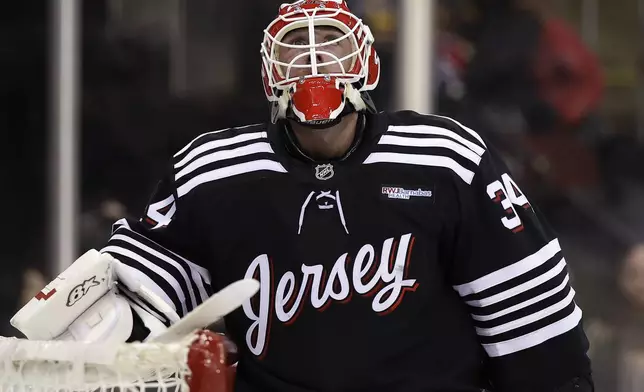New Jersey Devils goaltender Jake Allen reacts after giving up a goal to Pittsburgh Penguins center Evgeni Malkin in the first period of an NHL hockey game Friday, April 11, 2025, in Newark, N.J. (AP Photo/Adam Hunger)