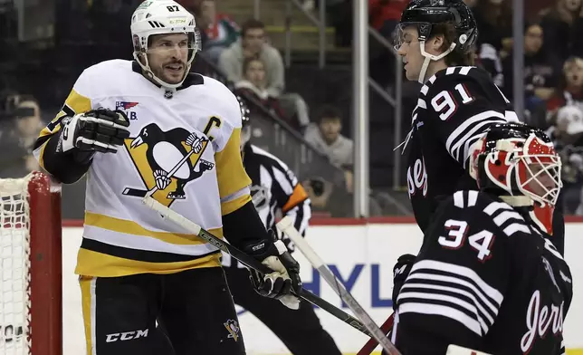 Pittsburgh Penguins center Sidney Crosby (87) reacts after scoring a goal past New Jersey Devils goaltender Jake Allen in the third period of an NHL hockey game Friday, April 11, 2025, in Newark, N.J. (AP Photo/Adam Hunger)
