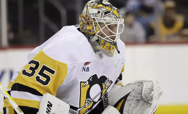 Pittsburgh Penguins goaltender Tristan Jarry defends his net in the second period of an NHL hockey game against the New Jersey Devils, Friday, April 11, 2025, in Newark, N.J. (AP Photo/Adam Hunger)