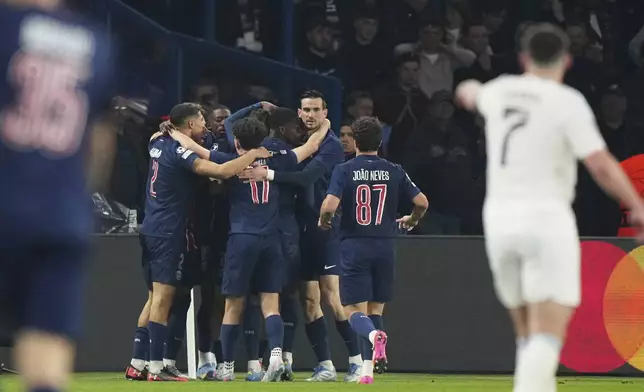 PSG players celebrate after Khvicha Kvaratskhelia scored their second goal during the Champions League quarterfinal first leg soccer match between Paris Saint-Germain and Aston Villa at Parc des Princes stadium in Paris, Wednesday, April 9, 2025. (AP Photo/Aurelien Morissard)