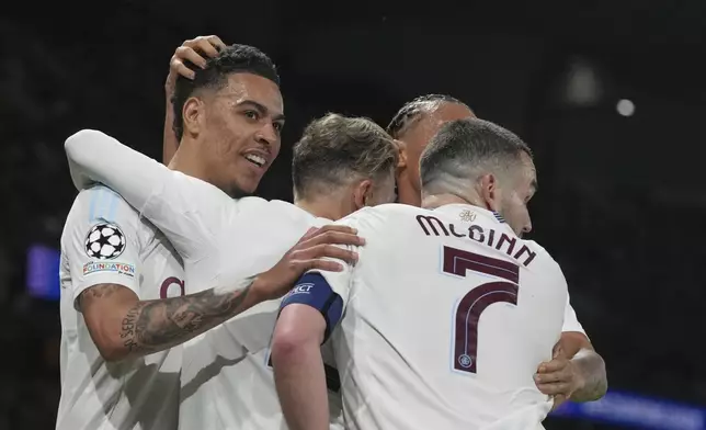 Aston Villa's Morgan Rogers, left, celebrates after scoring his side's opening goal during the Champions League quarterfinal first leg soccer match between Paris Saint-Germain and Aston Villa at Parc des Princes stadium in Paris, Wednesday, April 9, 2025. (AP Photo/Thibault Camus)