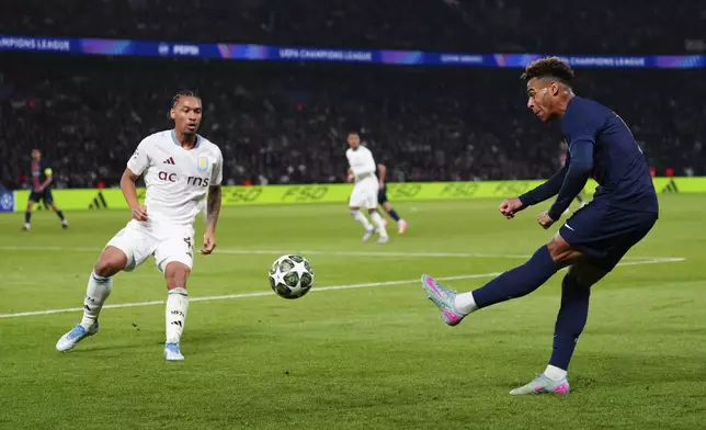 PSG's Desire Doue, right, takes a shot during the Champions League quarterfinal first leg soccer match between Paris Saint-Germain and Aston Villa at Parc des Princes stadium in Paris, Wednesday, April 9, 2025. (AP Photo/Aurelien Morissard)