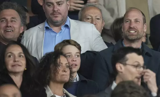 Britain's Prince William, right, with his eldest son Prince George on the stages during the Champions League quarterfinal first leg soccer match between Paris Saint-Germain and Aston Villa at Parc des Princes stadium in Paris, Wednesday, April 9, 2025. (AP Photo/Thibault Camus)