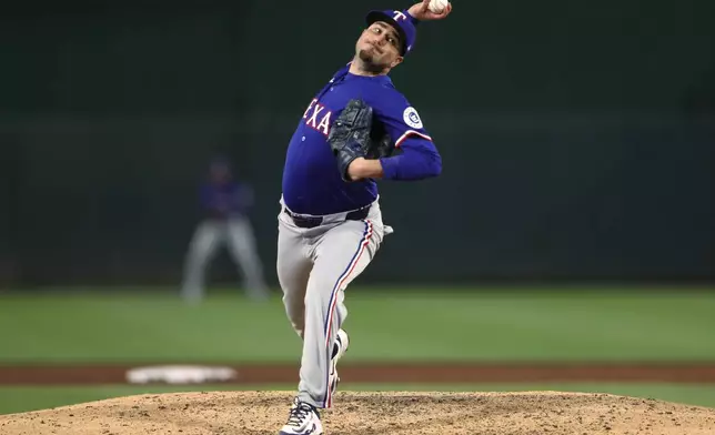 Texas Rangers pitcher Luke Jackson (77) delivers a pitch to an Athletics batter during the ninth inning of a baseball game Tuesday, April 22, 2025, in West Sacramento, Calif. (AP Photo/Scott Marshall)