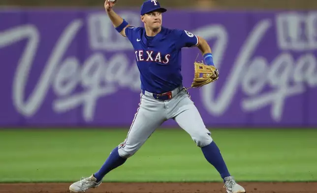 Texas Rangers third base Josh Jung (6) throws to first during the ninth inning of a baseball game against the Athletics, Tuesday, April 22, 2025, in West Sacramento, Calif. (AP Photo/Scott Marshall)