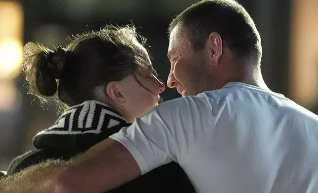 Ksenia Karelina walks with her fiancé, professional boxer Chris van Heerden, as she arrives Thursday, April 10, 2025, at Joint Base Andrews, Md. (AP Photo/Alex Brandon)