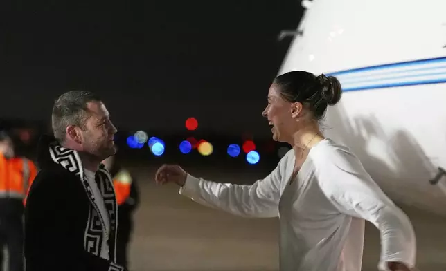 Ksenia Karelina greets her fiancé, professional boxer Chris van Heerden, as she arrives Thursday, April 10, 2025, at Joint Base Andrews, Md. (AP Photo/Alex Brandon)